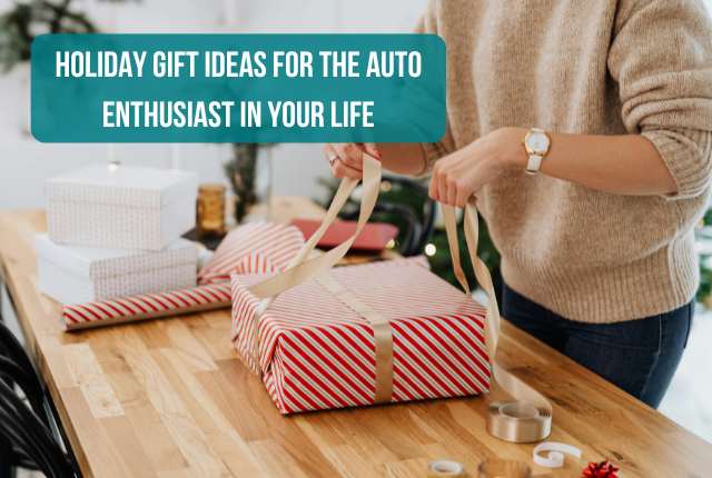 a person wrapping gifts and tying a bow on a present on a wooden table featuring the title, ' Holiday Gift Ideas for the Auto Enthusiast in your Life'